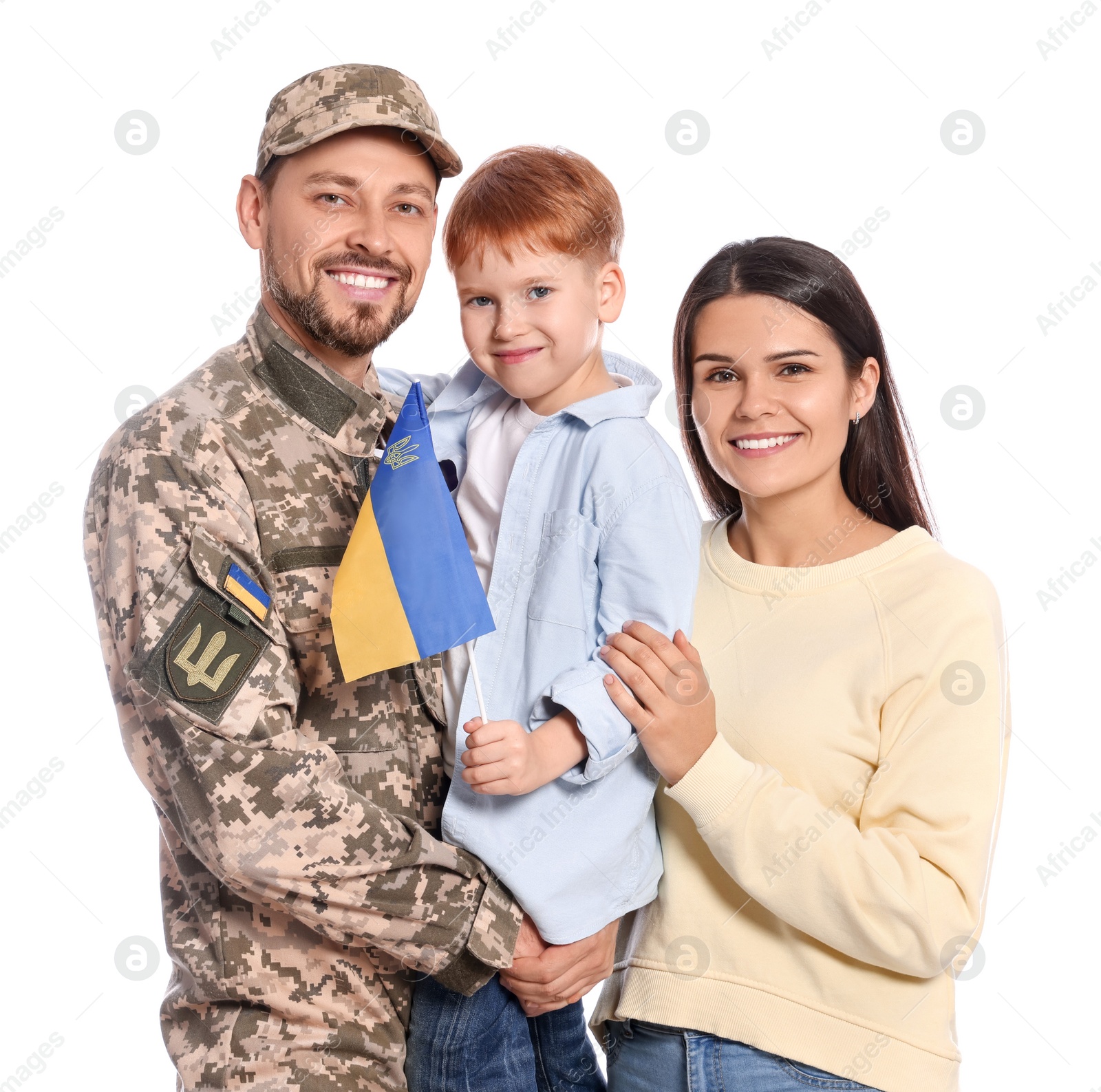 Photo of Ukrainian defender in military uniform and his family with flag on white background