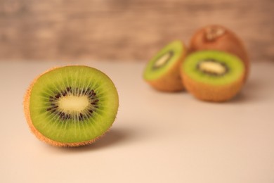 Delicious fresh ripe kiwi on beige background, space for text