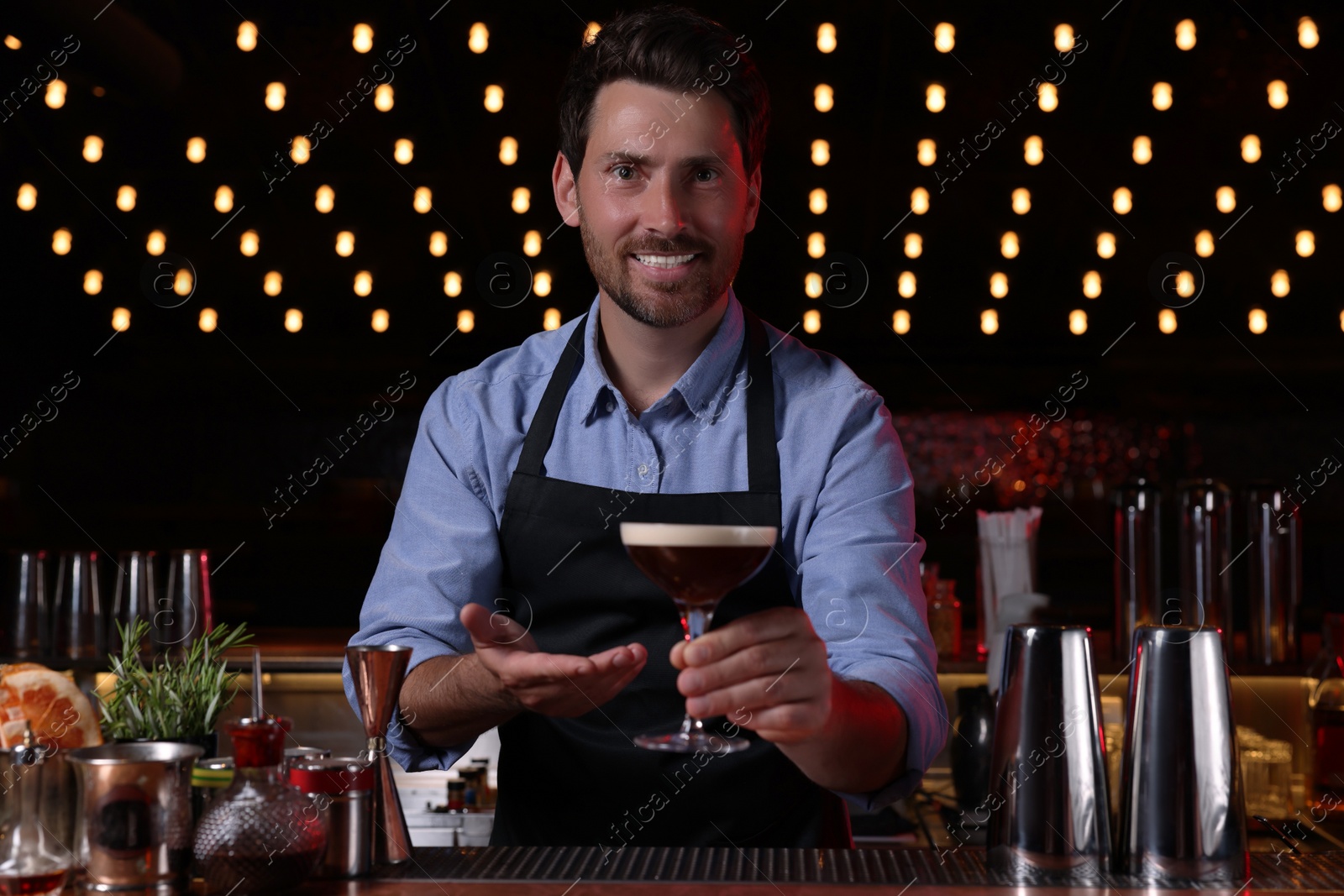 Photo of Bartender with Espresso Martini in bar. Alcohol cocktail