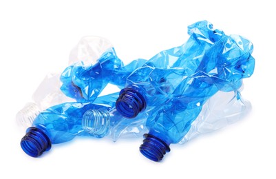 Photo of Crumpled disposable plastic bottles on white background