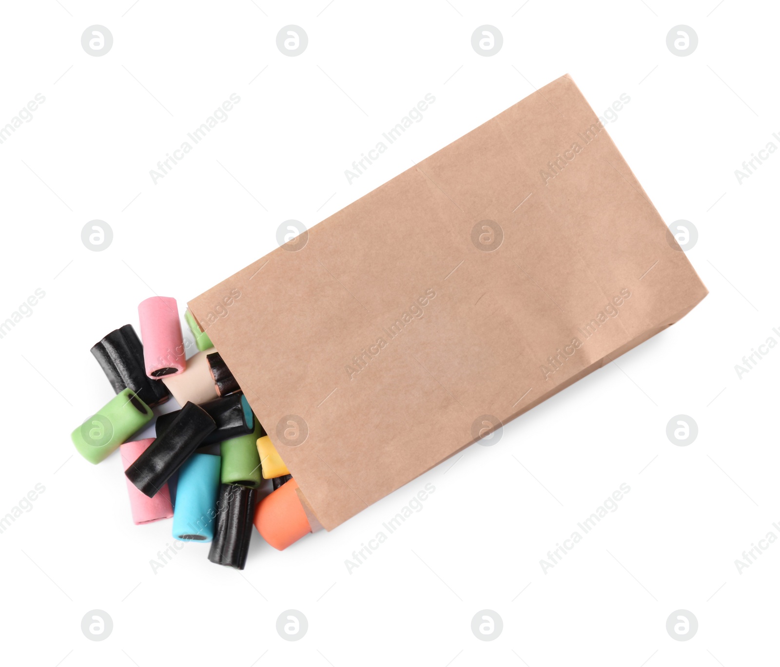 Photo of Kraft paper bag with tasty liquorice candies isolated on white, top view