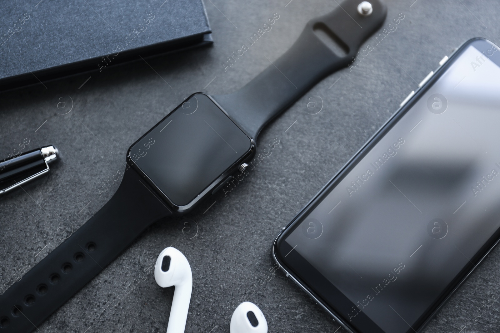 Composition with stylish smart watch on grey table, above view Photo of Composition with stylish smart watch on grey table, above view