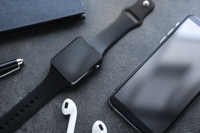 Photo of Composition with stylish smart watch on grey table, above view