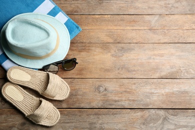 Photo of Beach accessories on wooden table, flat lay. Space for text