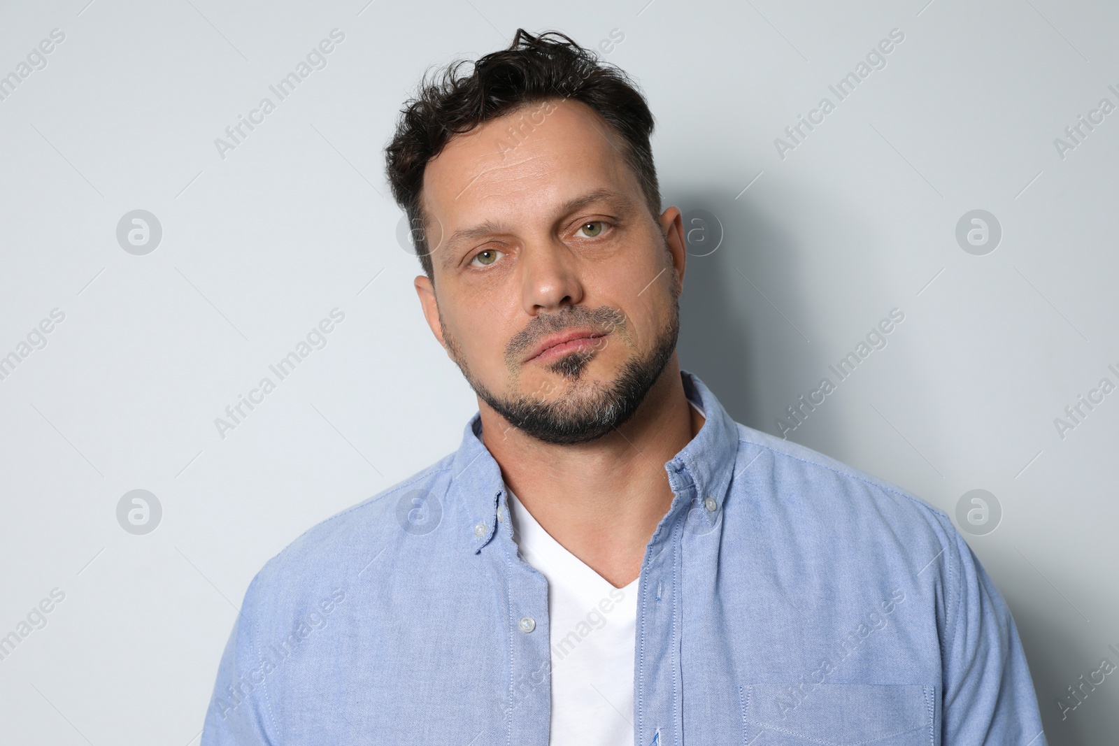 Photo of Portrait of handsome man on light grey background