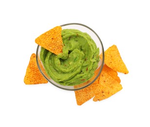 Photo of Bowl of delicious guacamole with nachos chips isolated on white, top view