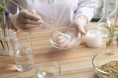 Photo of Scientist developing cosmetic product in laboratory, closeup