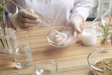 Scientist developing cosmetic product in laboratory, closeup