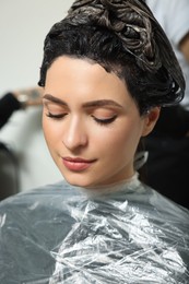 Photo of Young woman with dyed hair in beauty salon, closeup view