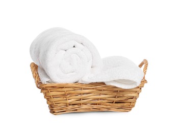 Photo of Wicker basket with rolled bath towels isolated on white