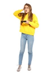 Emotional young woman playing video games with controller isolated on white