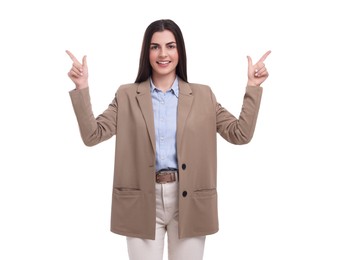 Beautiful happy businesswoman pointing at something on white background