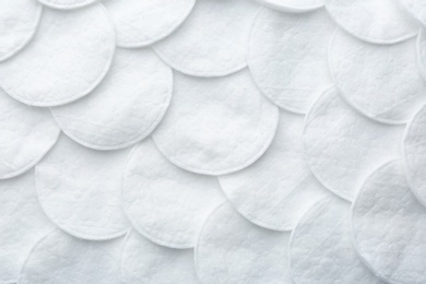 Photo of Many cotton pads as background, top view