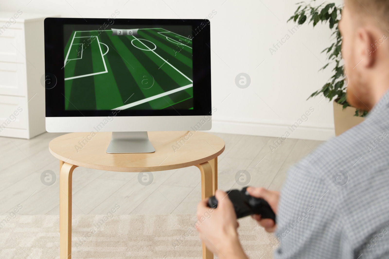 Photo of Young man playing video games at home, closeup