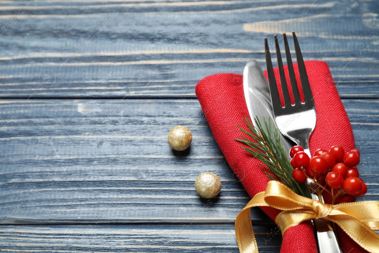 Photo of Cutlery set on blue wooden table. Space for text