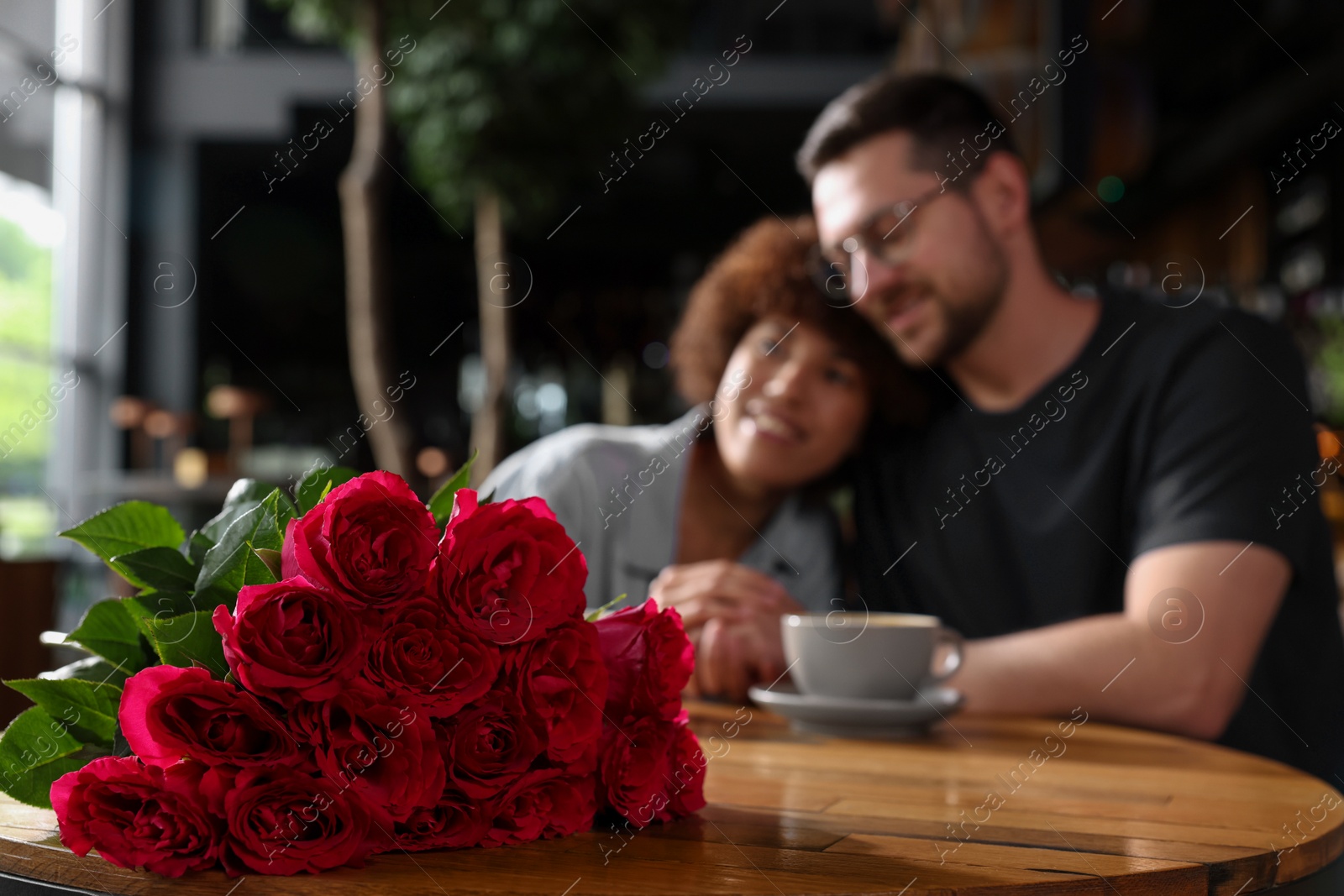 Photo of International dating. Happy couple spending time together in restaurant, selective focus