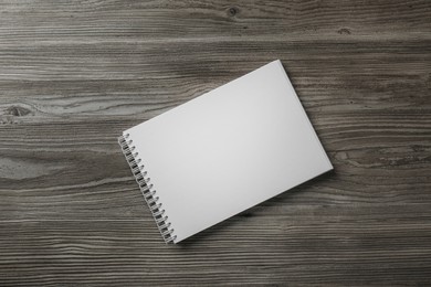 Photo of Blank paper brochure on wooden table, top view. Mockup for design