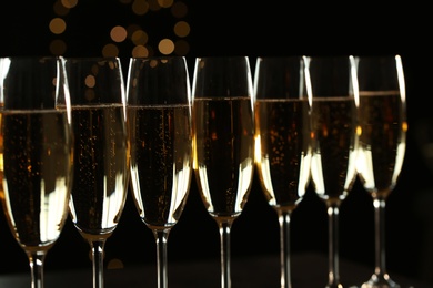 Many glasses of champagne on blurred background, closeup