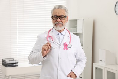 Mammologist with pink ribbon in hospital. Breast cancer awareness