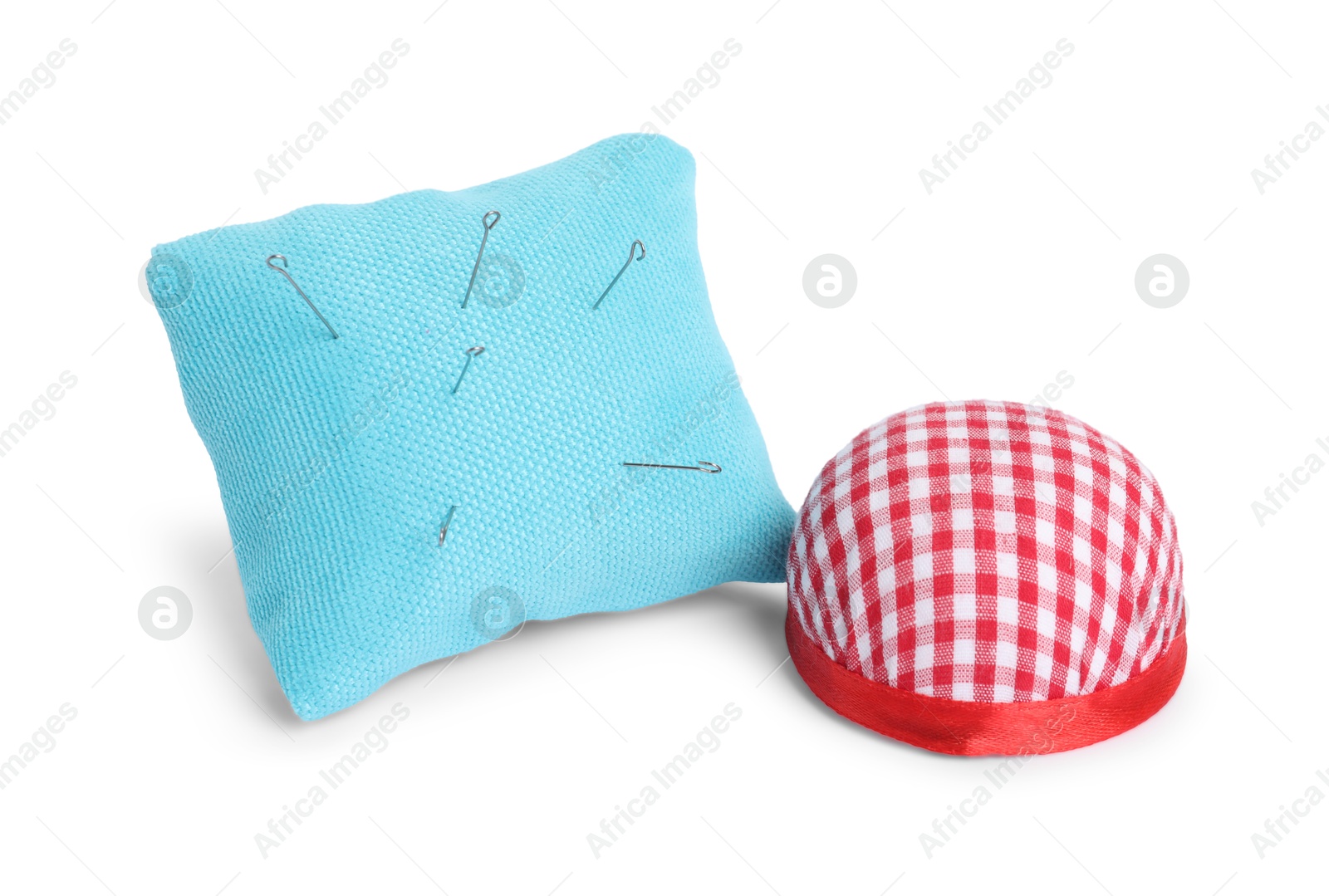 Photo of Pincushions and sewing needles isolated on white