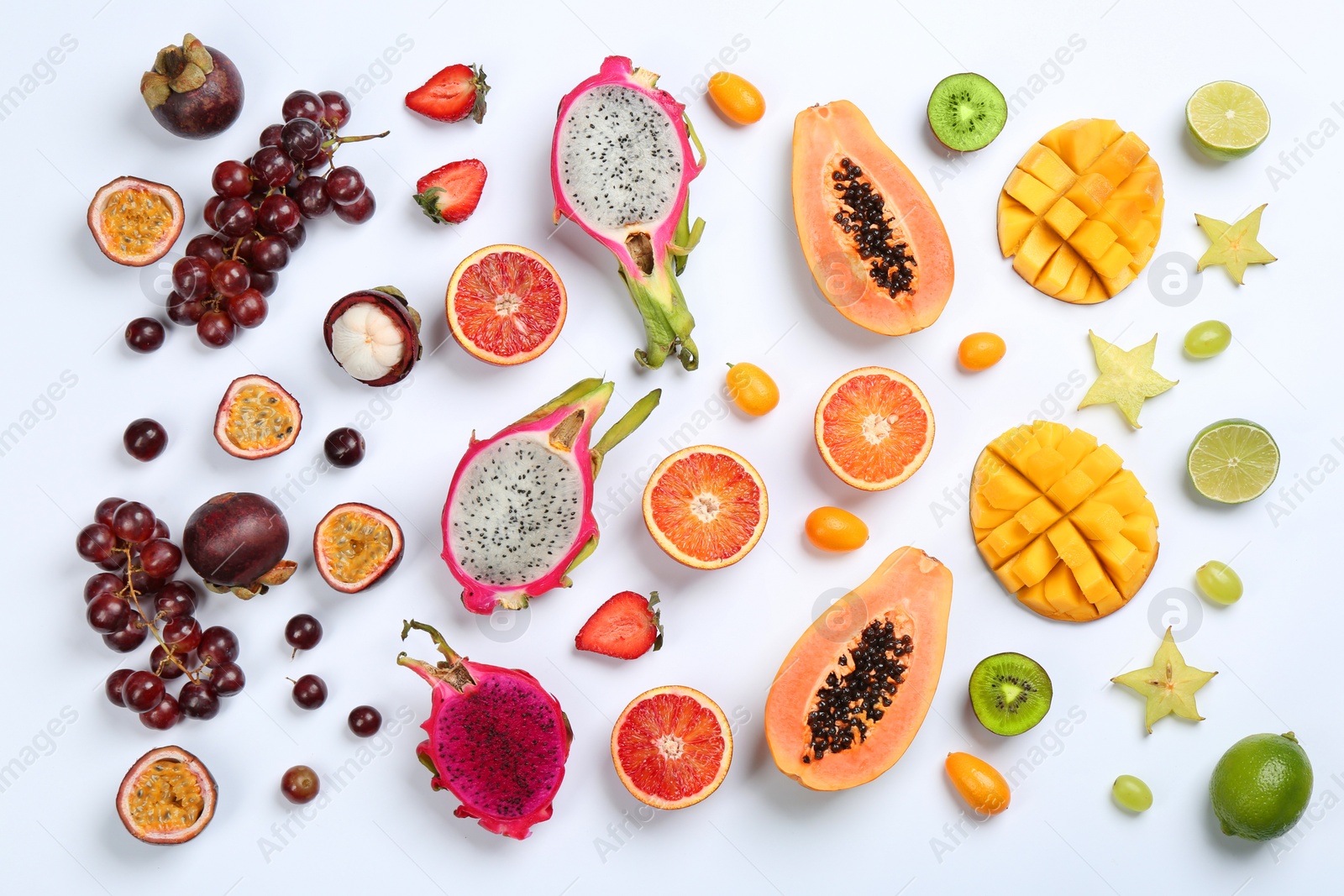 Photo of Many different delicious exotic fruits on white background, flat lay