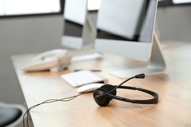 Modern headset on table in technical support office