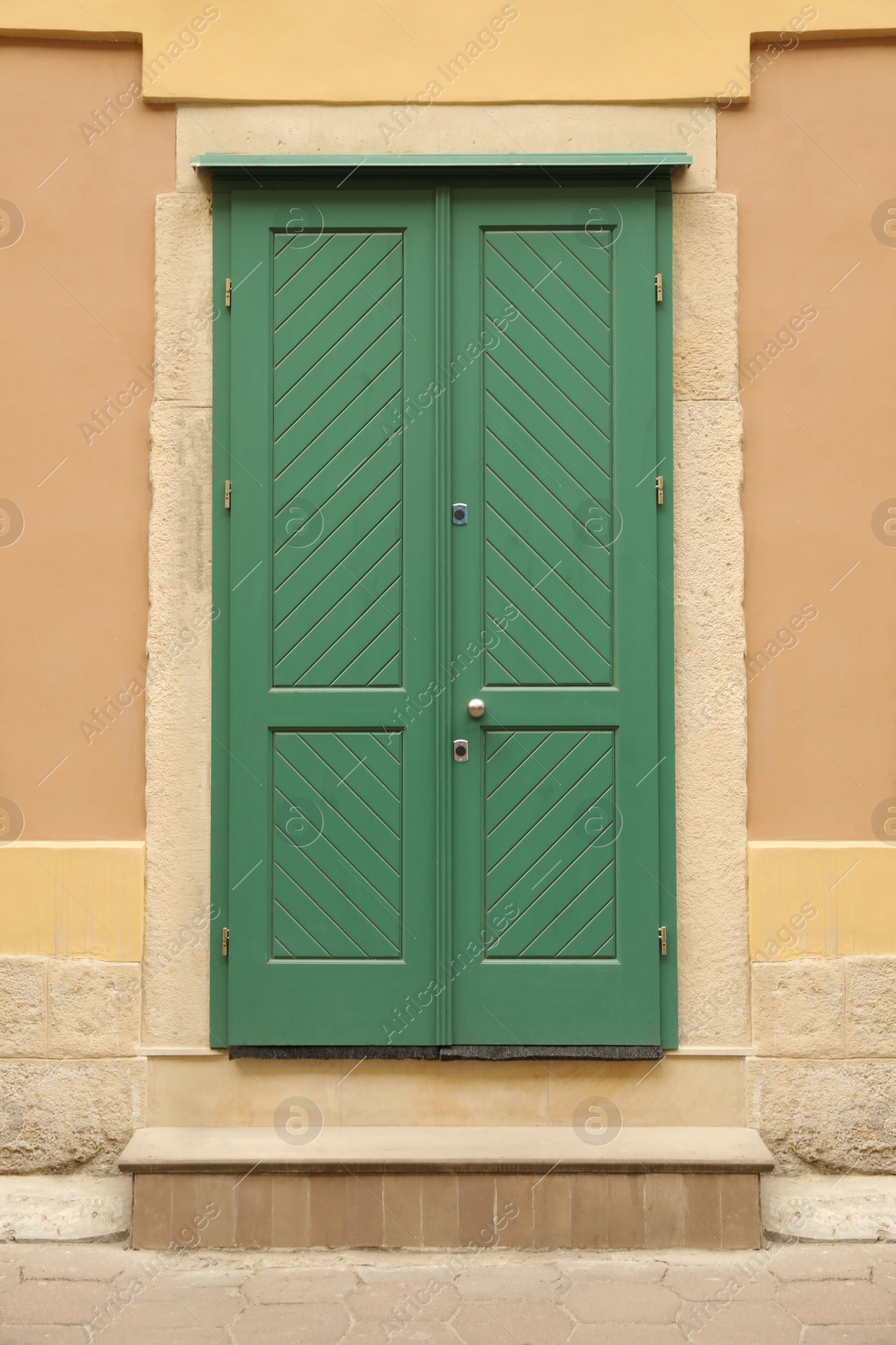 Photo of View of building with turquoise wooden door. Exterior design