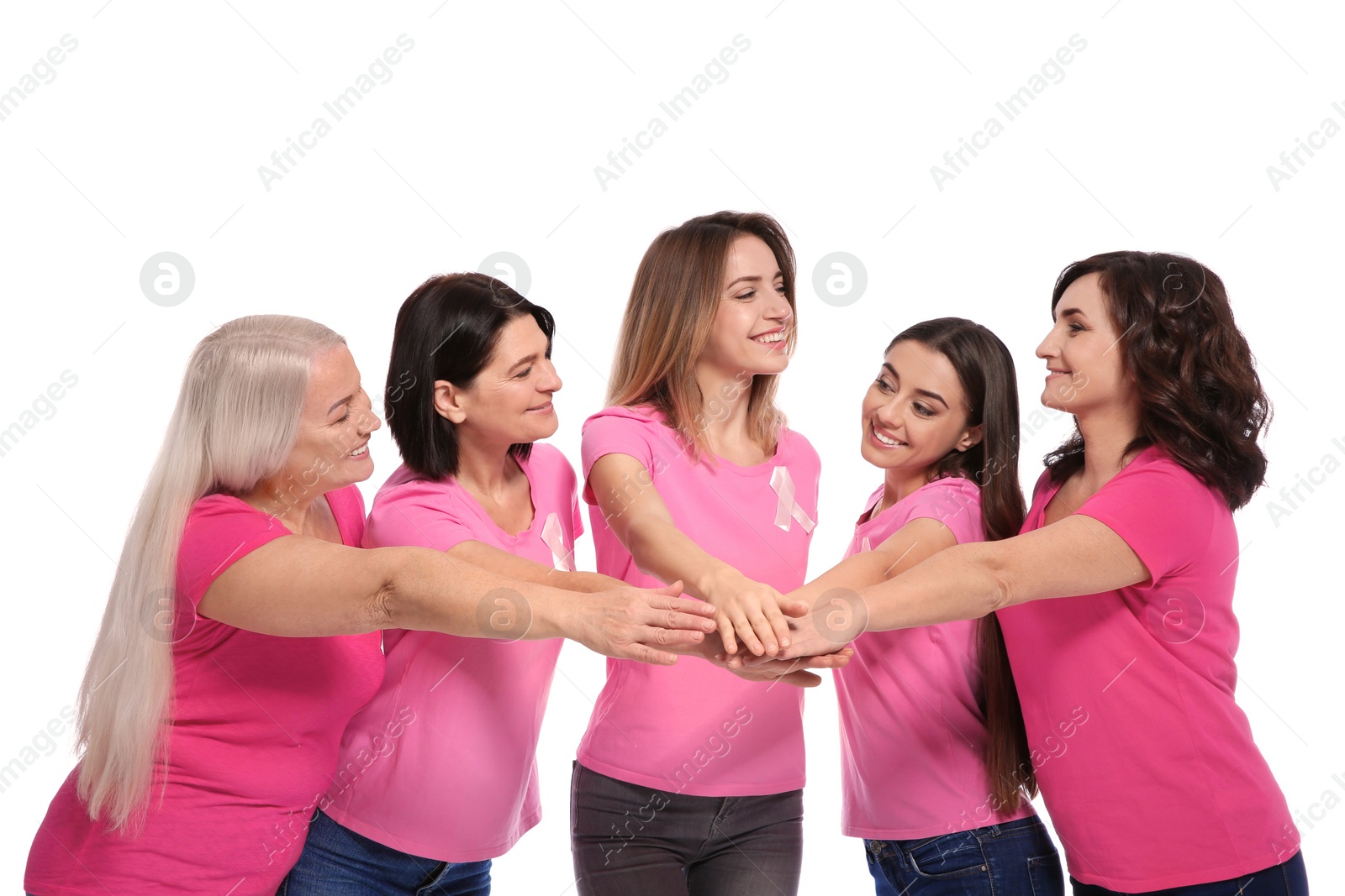 Photo of Group of women with silk ribbons joining hands on white background. Breast cancer awareness concept