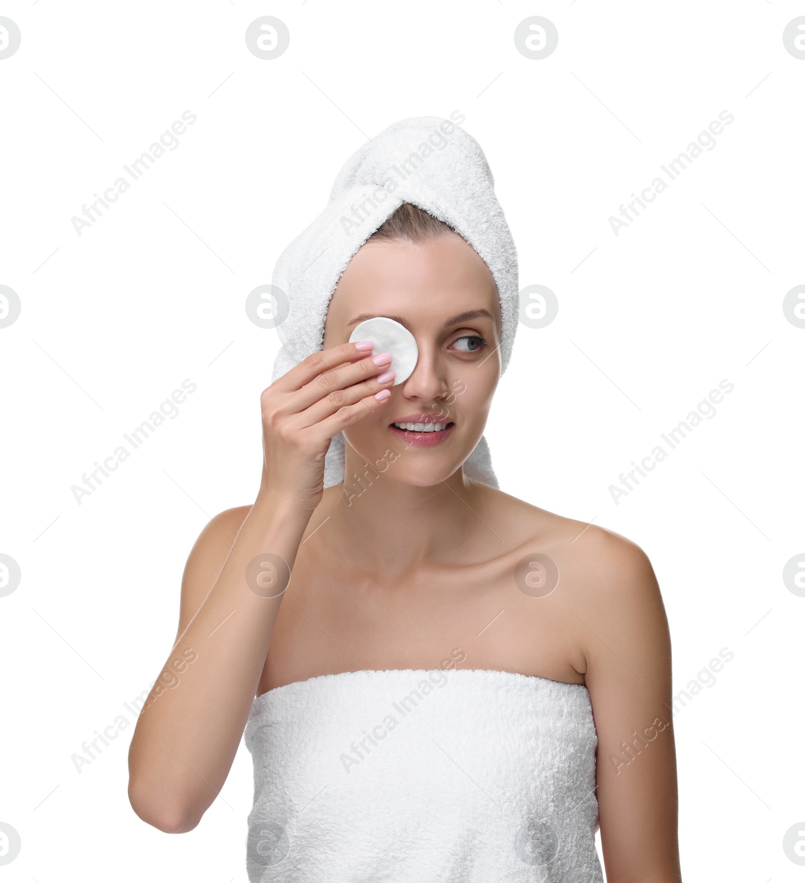 Photo of Young woman cleaning her face with cotton pad on white background