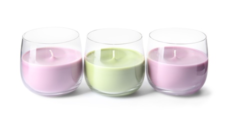 Color wax candles in glass holders isolated on white