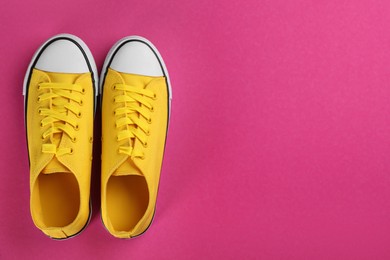 Photo of Pair of trendy sneakers on pink background, flat lay. Space for text