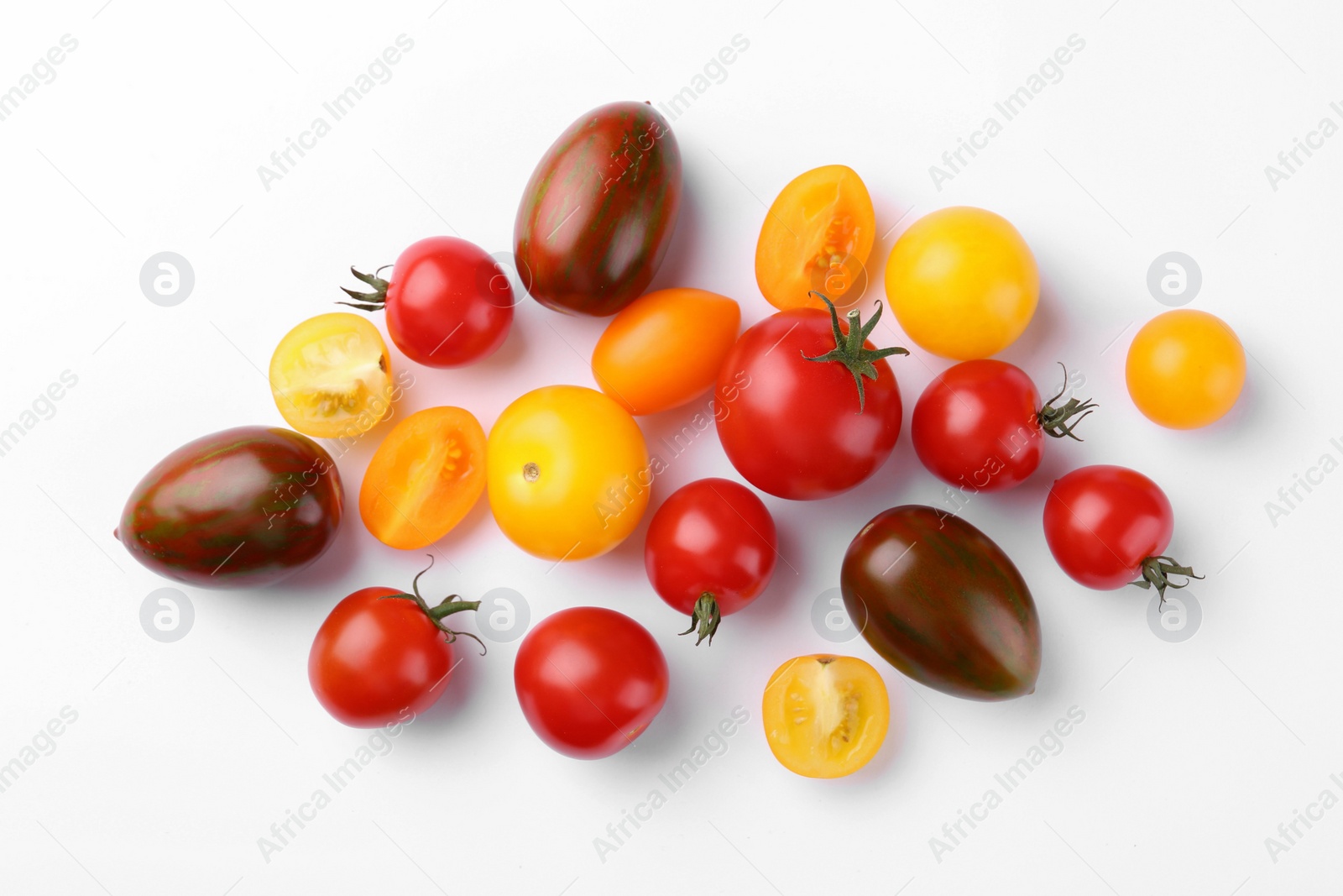 Photo of Flat lay composition with different whole and cut tomatoes on white background