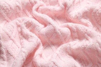 Photo of Texture of soft pink knitted fabric as background, closeup