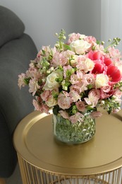Photo of Beautiful bouquet of fresh flowers on coffee table in room