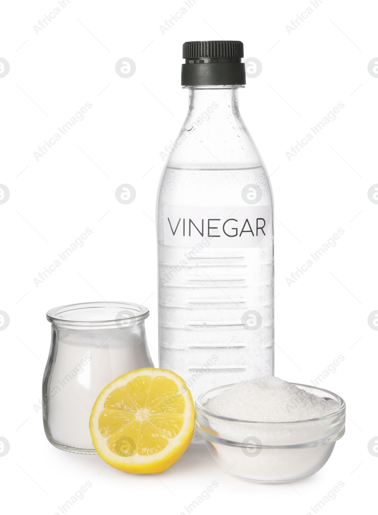 Photo of Eco friendly natural cleaners. Vinegar in bottle, cut lemon and soda isolated on white