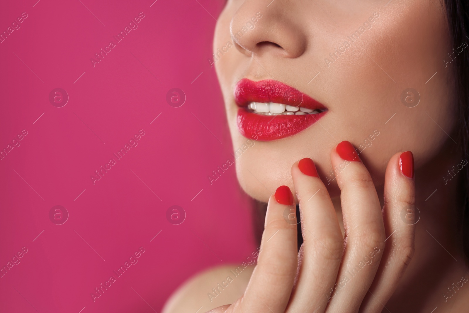 Photo of Beautiful woman with stylish nail polish on color background, closeup. Space for text