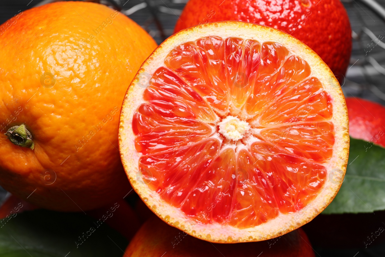 Photo of Closeup view of fresh ripe red oranges on table