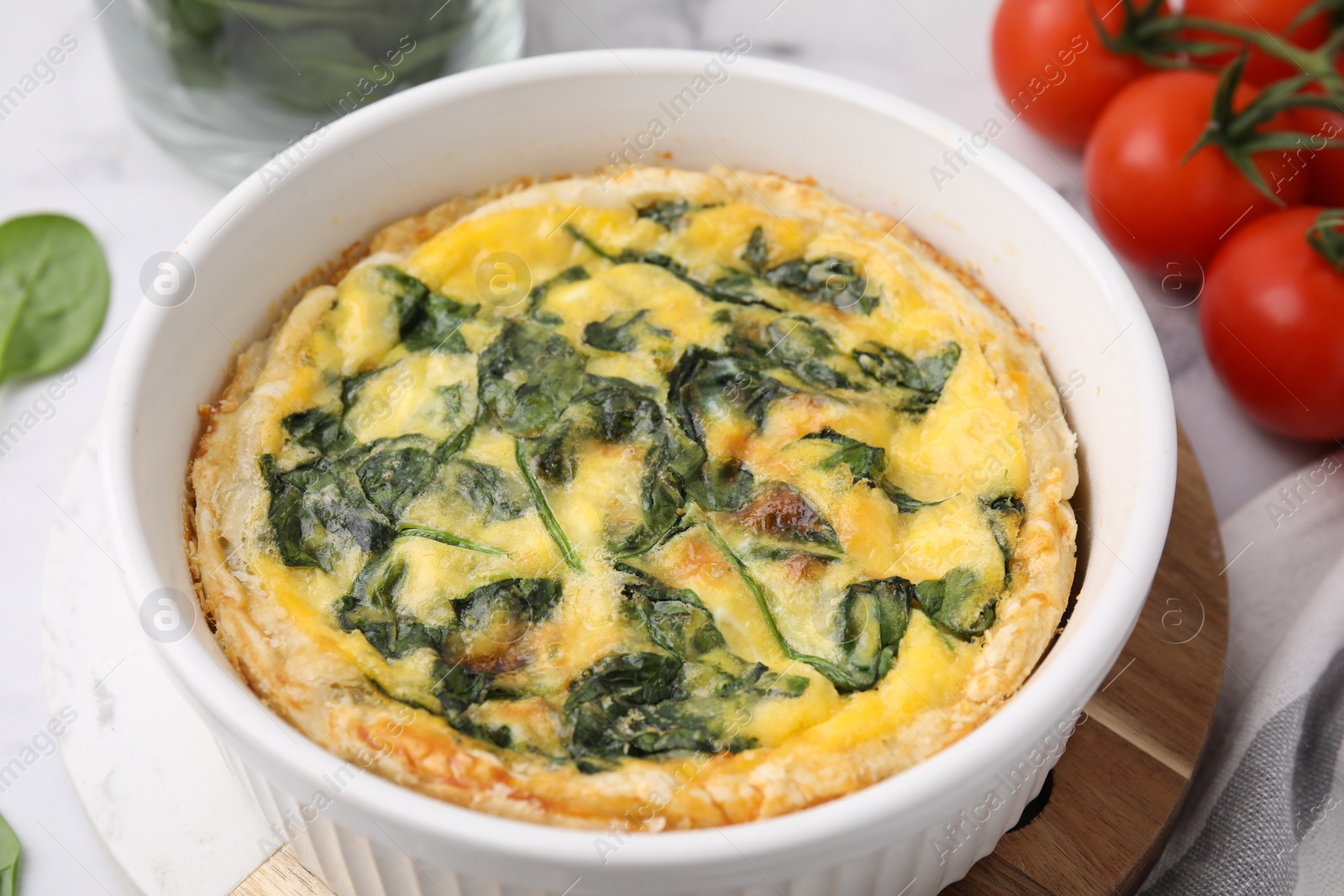 Photo of Delicious pie with spinach on table, closeup