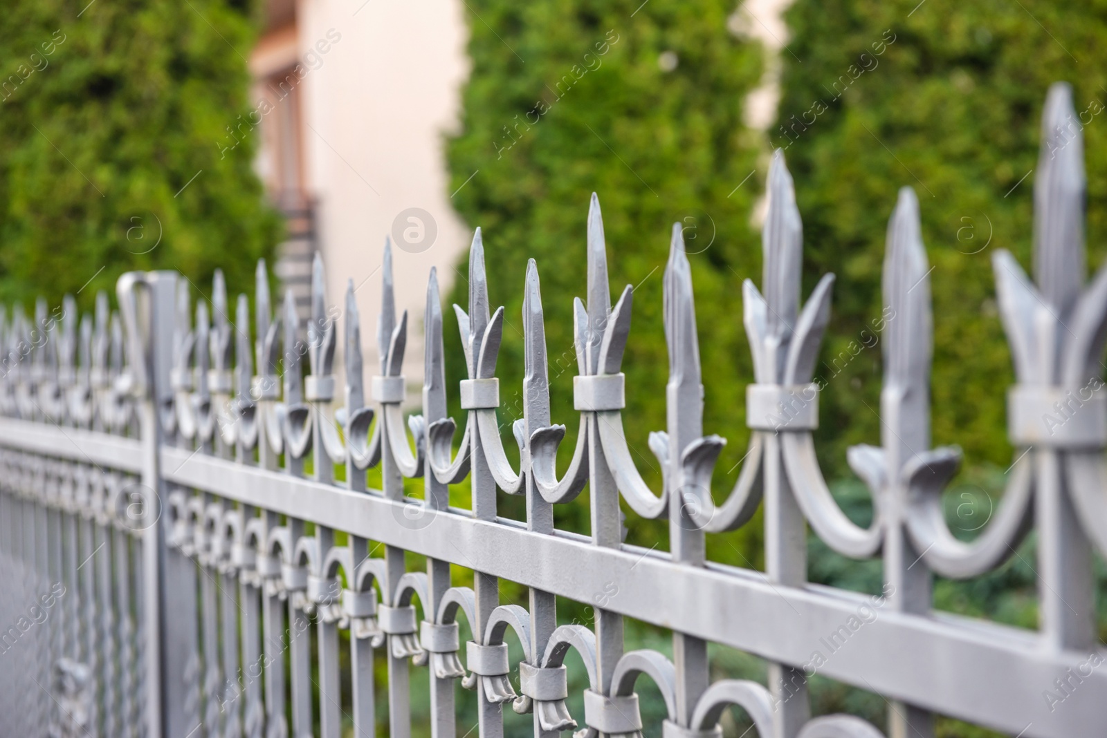 Photo of Railing of beautiful iron fence outdoors, closeup