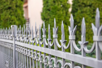 Photo of Railing of beautiful iron fence outdoors, closeup