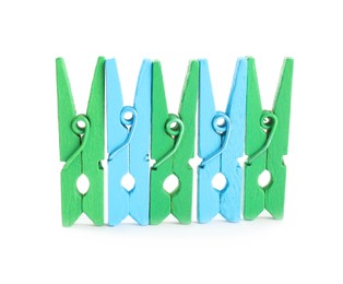 Many colorful wooden clothespins on white background