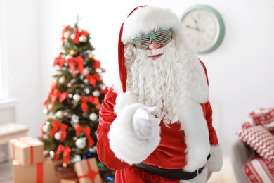 Authentic Santa Claus with funny glasses indoors
