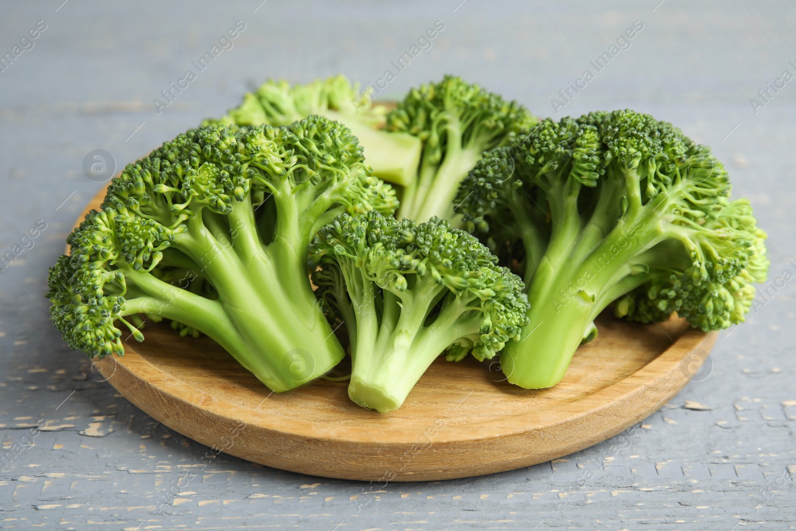 Photo of Fresh green broccoli on wooden table. Organic food