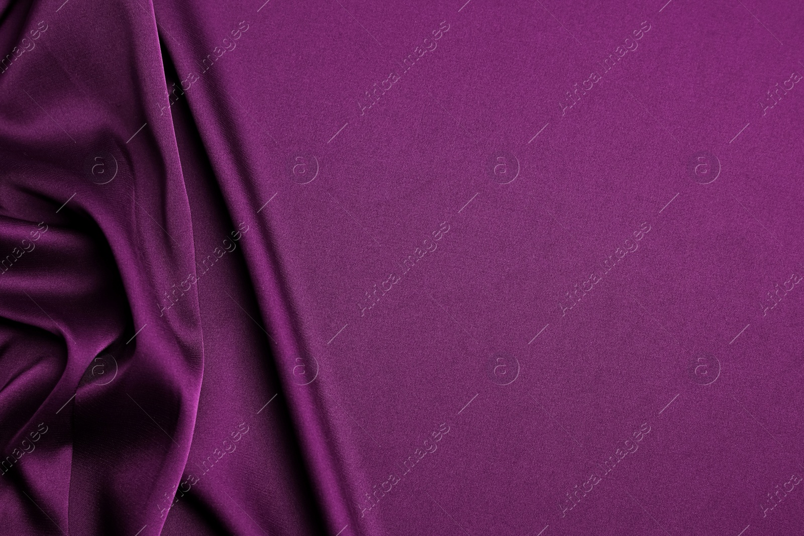 Image of Crumpled purple silk fabric as background, top view. Space for text