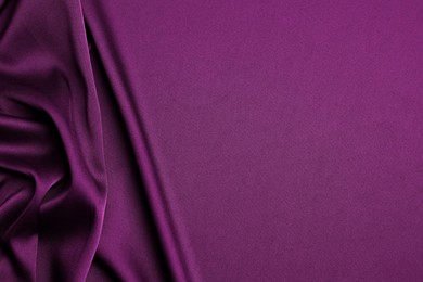 Image of Crumpled purple silk fabric as background, top view. Space for text