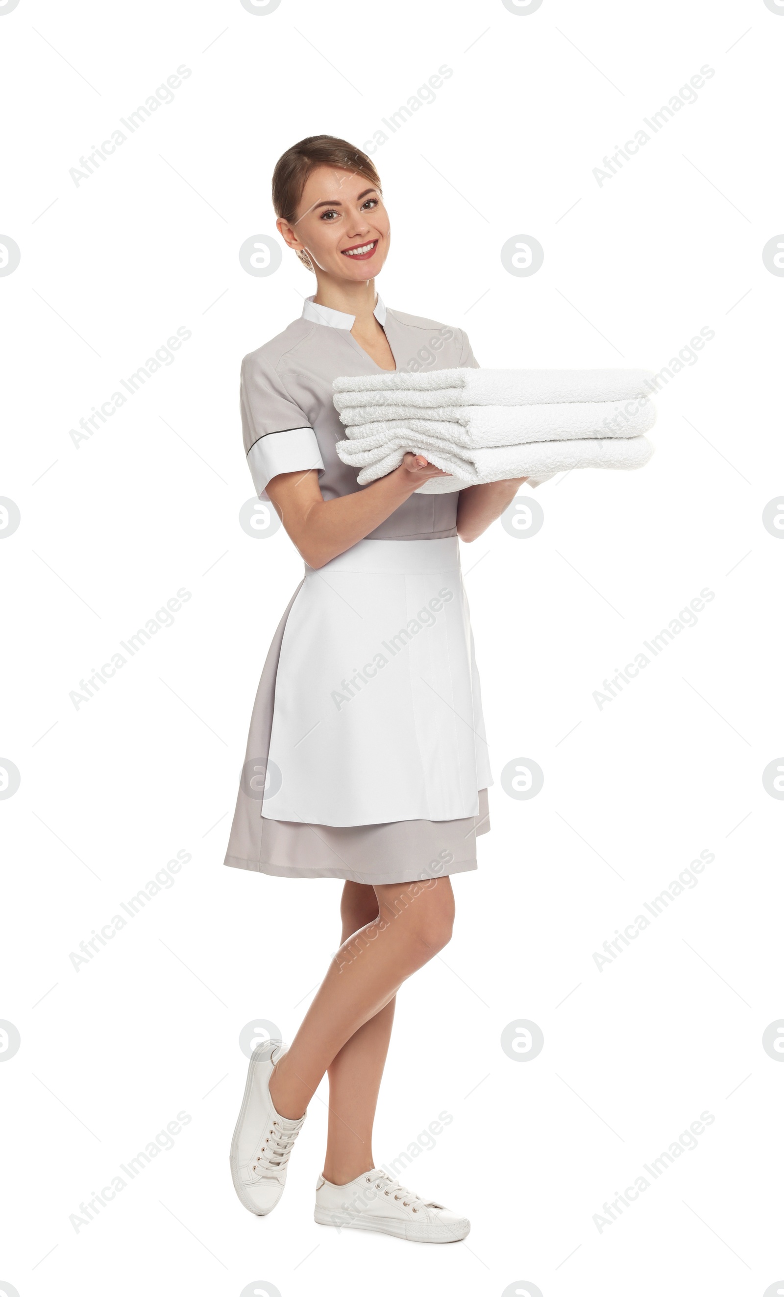 Photo of Full length portrait of chambermaid with towels on white background