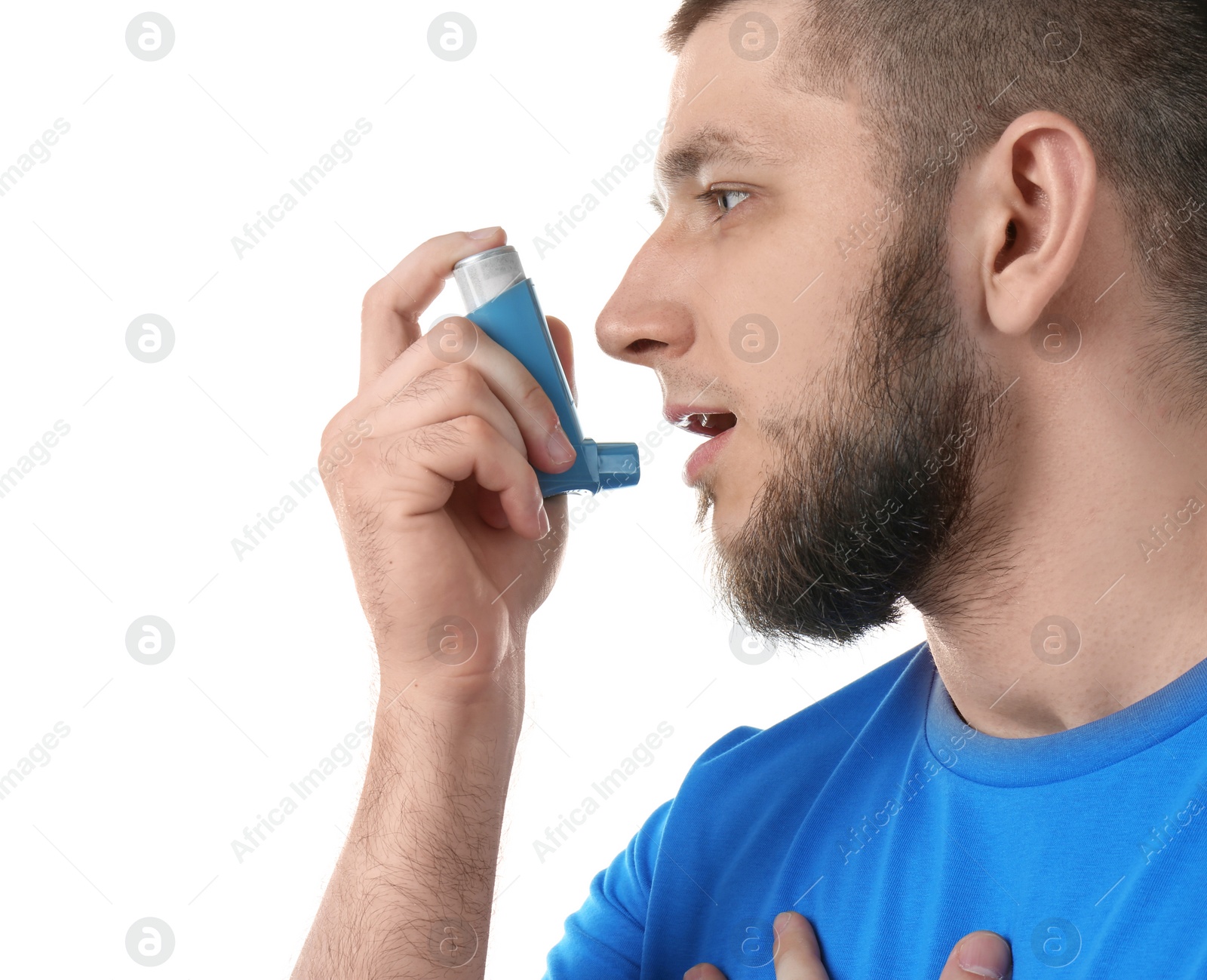 Photo of Young man using asthma inhaler on white background