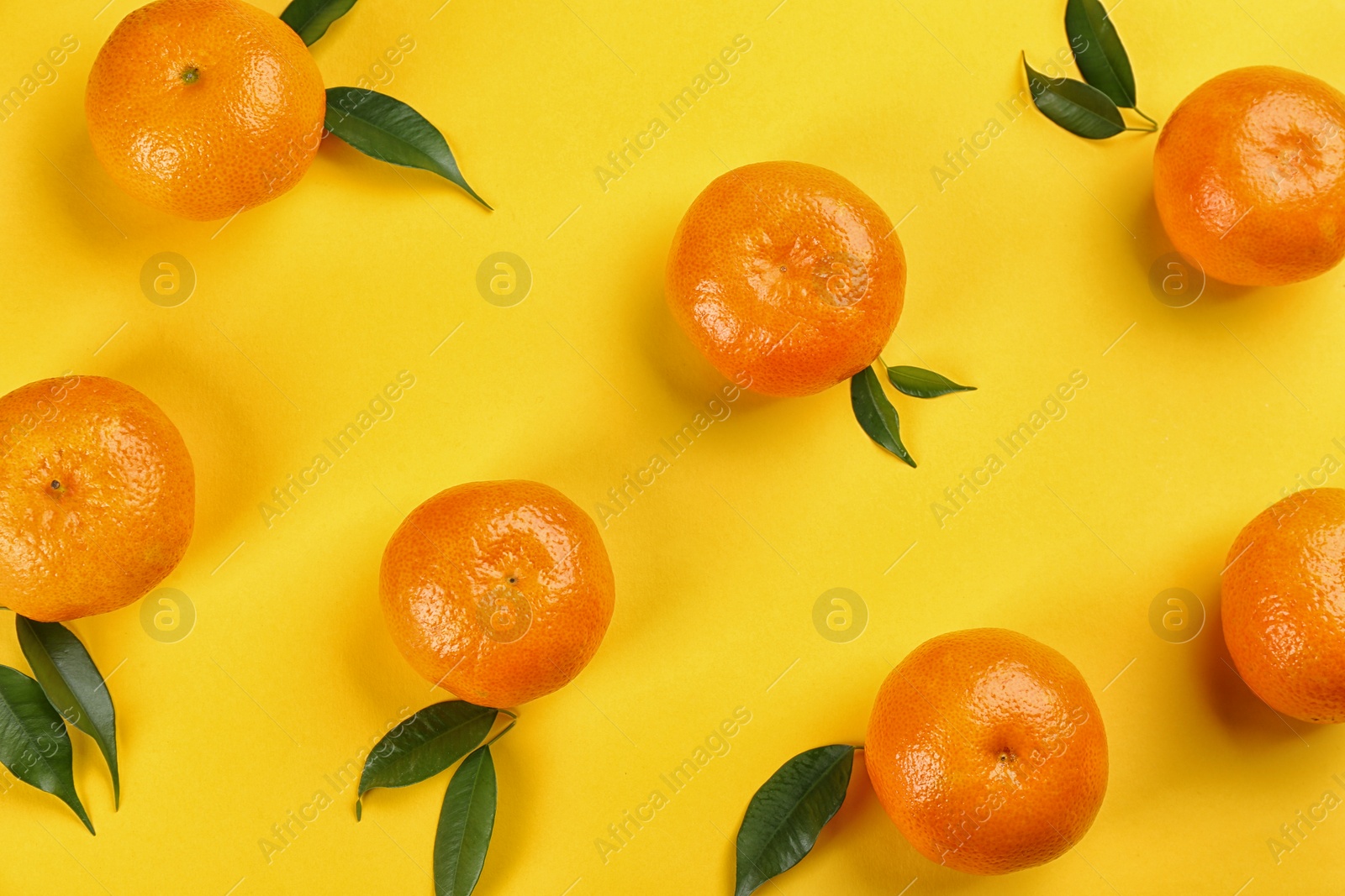 Photo of Flat lay composition with tangerines on yellow background