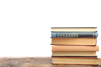 Photo of Stack of old vintage books on wooden table against white background