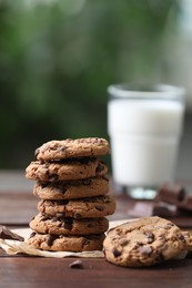 Photo of Delicious chocolate chip cookies on wooden table, closeup